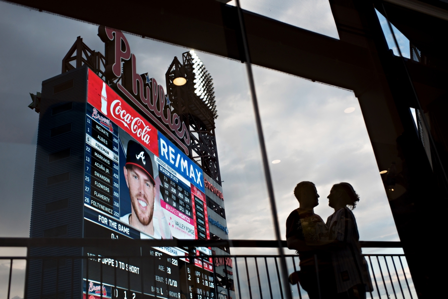 A silhouette of a bride and groom at the end of their reception at a Phillies game at Citizens Bank Park.